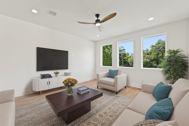 living room with ceiling fan and light wood-type flooring