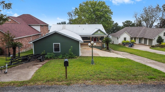 ranch-style house with a front yard and metal roof