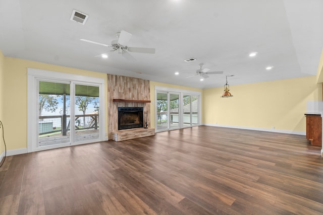 unfurnished living room featuring a fireplace, dark wood-type flooring, and ceiling fan