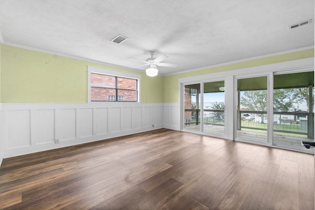 unfurnished room with dark hardwood / wood-style flooring, a textured ceiling, ceiling fan, and crown molding