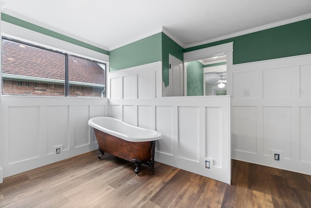 bathroom with hardwood / wood-style floors, ceiling fan, a washtub, and crown molding