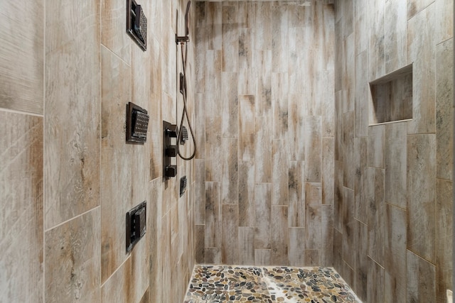 bathroom with tiled shower