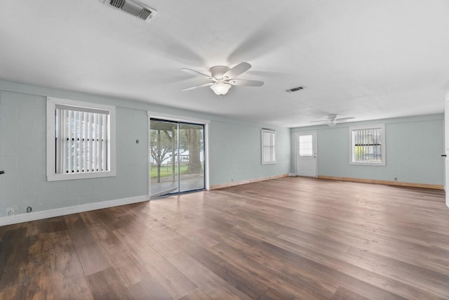 unfurnished room featuring visible vents, baseboards, ceiling fan, and wood finished floors