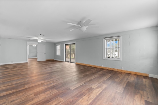 spare room with plenty of natural light, dark wood-type flooring, and ceiling fan