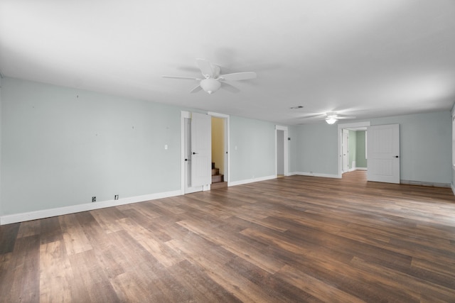 unfurnished room featuring dark wood-type flooring and ceiling fan