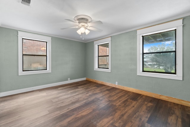 spare room featuring ceiling fan, dark hardwood / wood-style floors, and crown molding