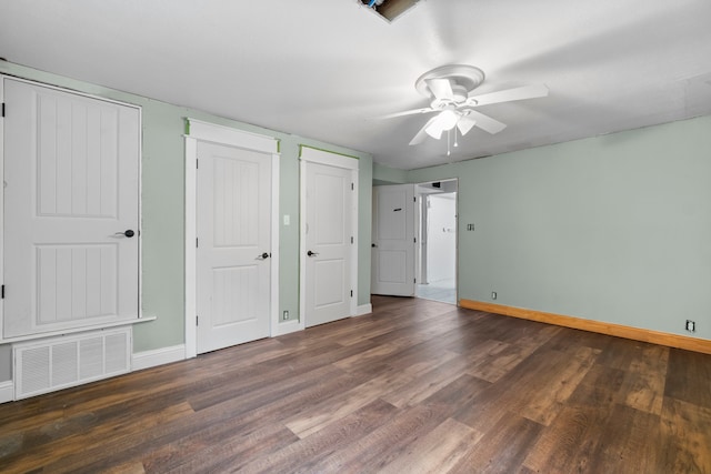 unfurnished bedroom featuring dark wood-type flooring and ceiling fan