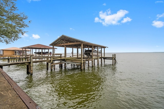 dock area with a water view and boat lift