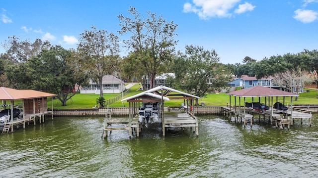 view of dock featuring a yard, a water view, and boat lift