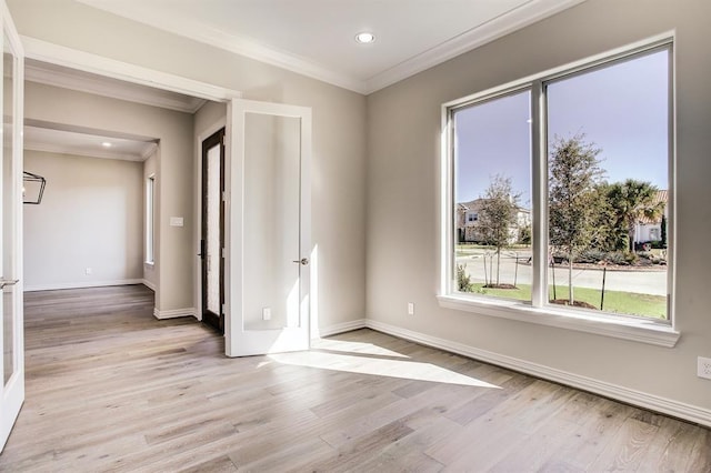 unfurnished room featuring crown molding and light hardwood / wood-style floors