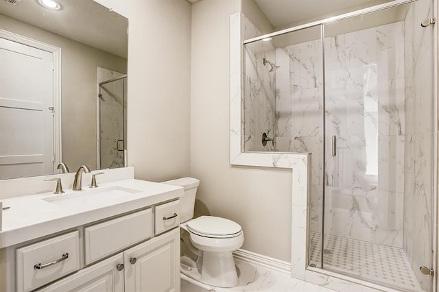 bathroom with vanity, toilet, and a shower with shower door