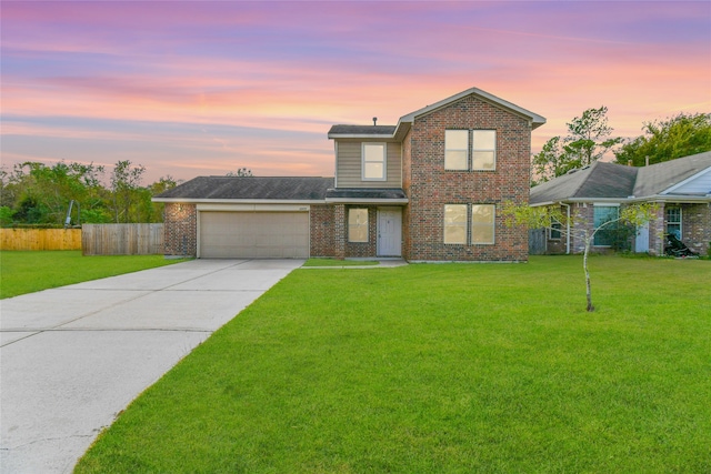 view of property featuring a yard and a garage