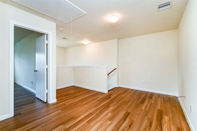 unfurnished room with hardwood / wood-style flooring