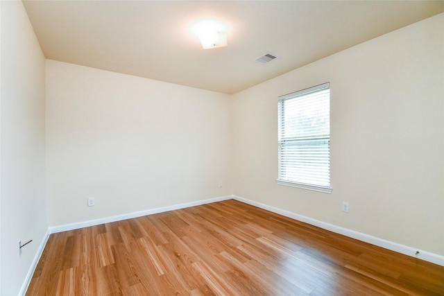 spare room featuring light hardwood / wood-style floors