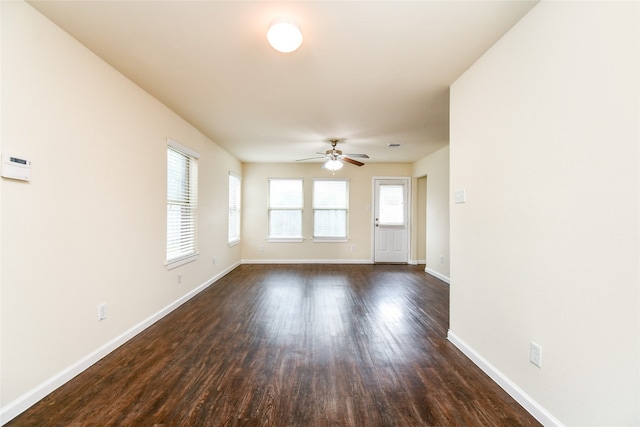 unfurnished living room with dark hardwood / wood-style floors and ceiling fan