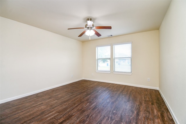 spare room with ceiling fan and dark hardwood / wood-style floors