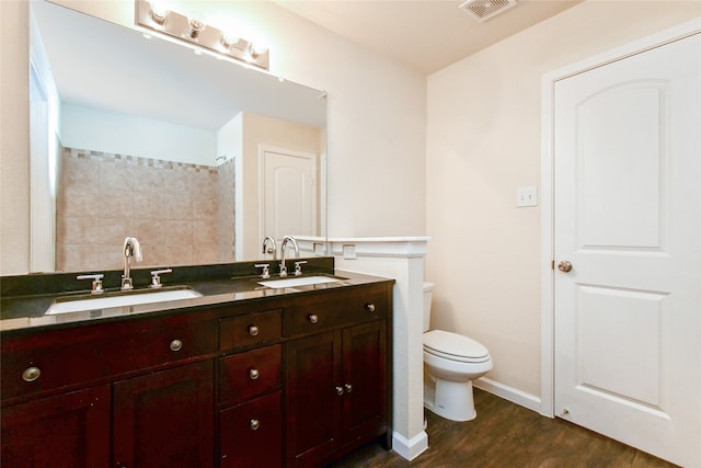 bathroom featuring hardwood / wood-style floors, vanity, and toilet