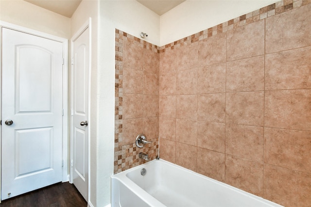 bathroom featuring hardwood / wood-style flooring and tiled shower / bath combo