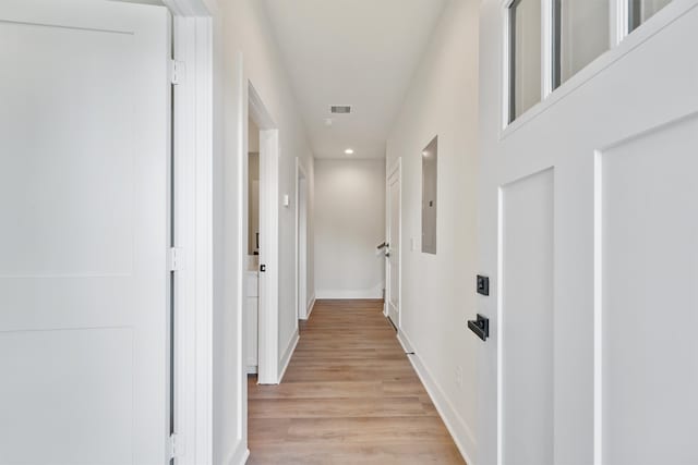 hall with light hardwood / wood-style floors