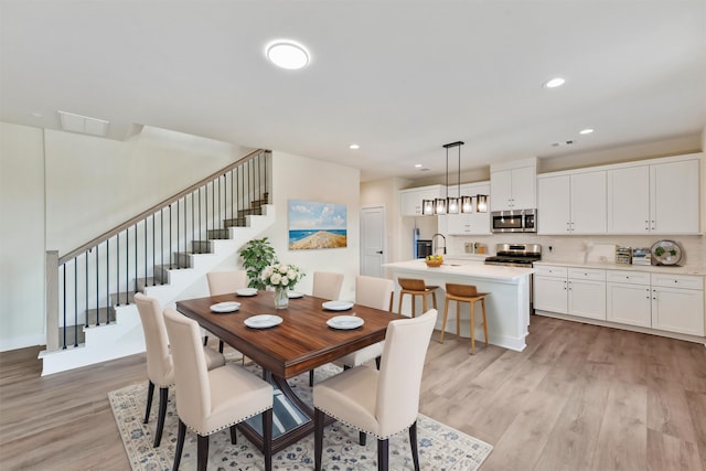 dining room with light hardwood / wood-style flooring