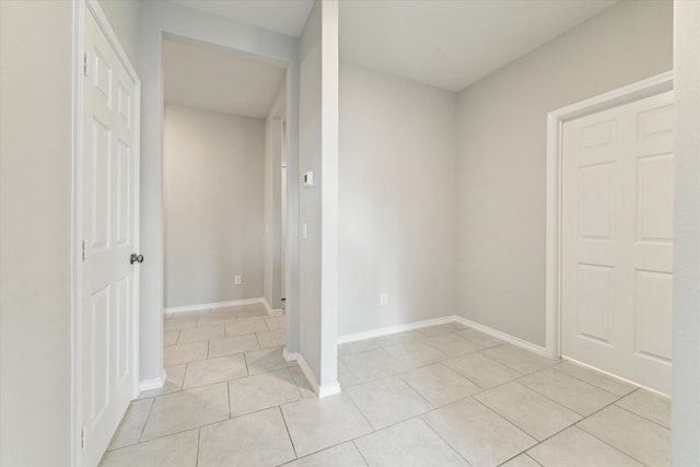 corridor featuring light tile patterned floors