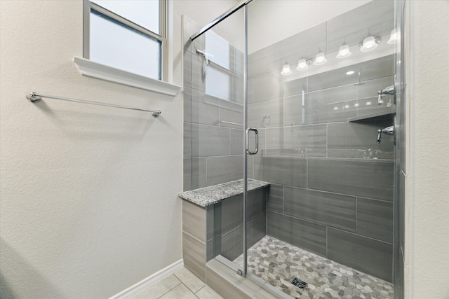 bathroom featuring walk in shower and tile patterned flooring