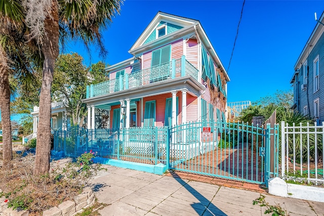 view of front of house with a balcony and covered porch