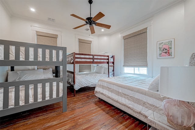 bedroom with wood-type flooring, ceiling fan, and crown molding