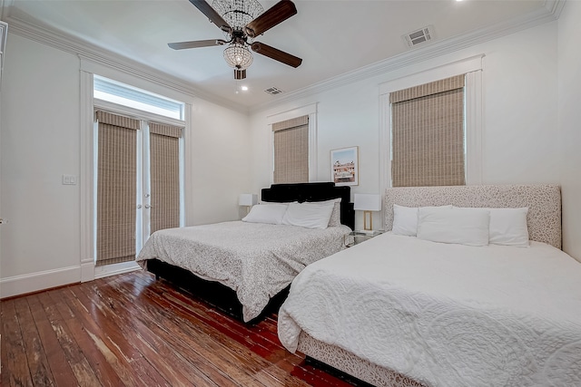 bedroom featuring dark hardwood / wood-style flooring, ceiling fan, and crown molding