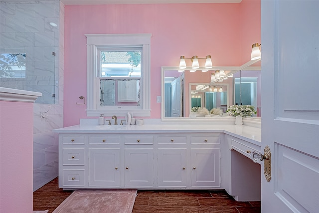 bathroom with tile walls, a shower, vanity, and hardwood / wood-style floors