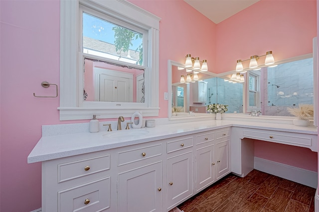 bathroom featuring a shower, wood-type flooring, and vanity