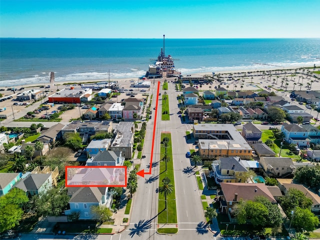 birds eye view of property featuring a beach view and a water view