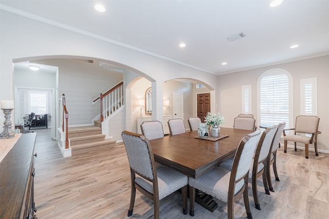 dining space featuring a wealth of natural light, light hardwood / wood-style floors, and ornamental molding