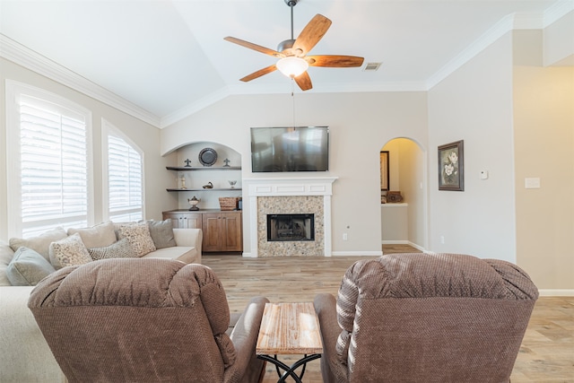 living room featuring built in features, light hardwood / wood-style floors, and ornamental molding