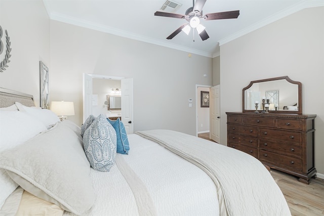 bedroom featuring ceiling fan, light hardwood / wood-style floors, crown molding, and ensuite bathroom