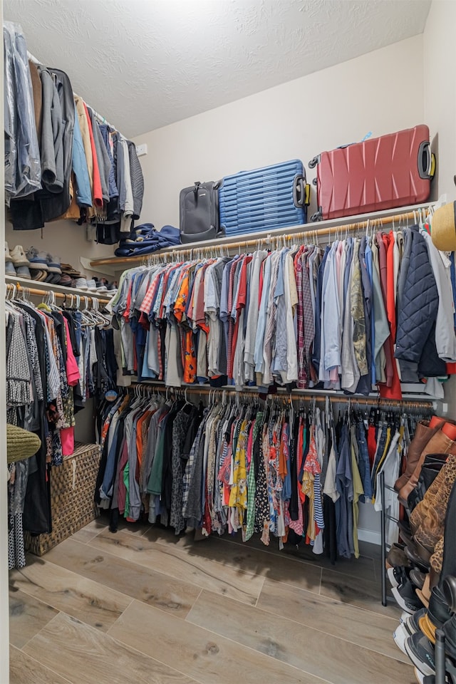 spacious closet featuring hardwood / wood-style floors