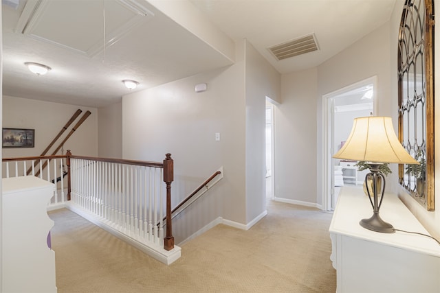 hall featuring light colored carpet