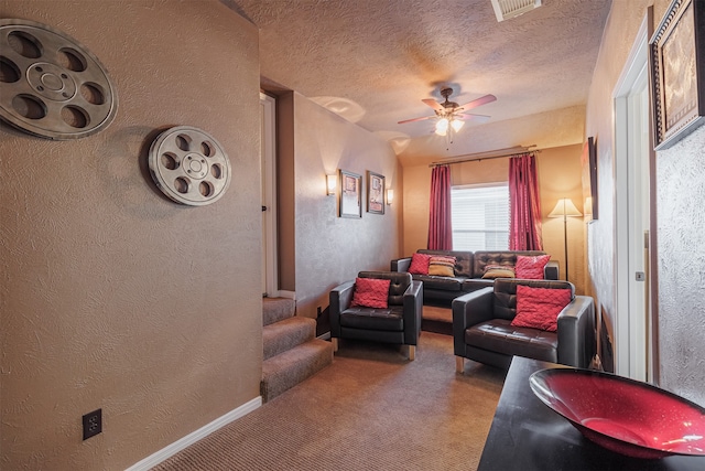 living room featuring ceiling fan, light colored carpet, and a textured ceiling