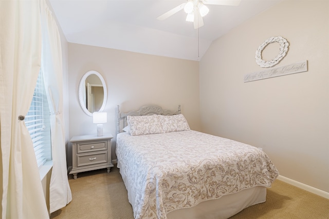 carpeted bedroom with vaulted ceiling and ceiling fan