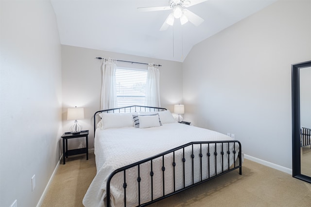 bedroom with ceiling fan, light colored carpet, and vaulted ceiling