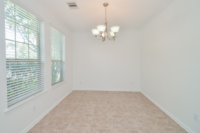 spare room featuring light tile patterned flooring, a wealth of natural light, crown molding, and a notable chandelier