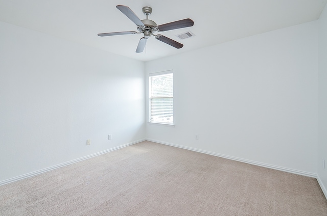 empty room featuring light colored carpet and ceiling fan