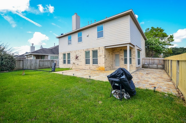 back of house featuring a yard and a patio