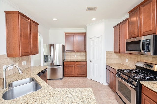 kitchen featuring light stone counters, sink, tasteful backsplash, ornamental molding, and appliances with stainless steel finishes