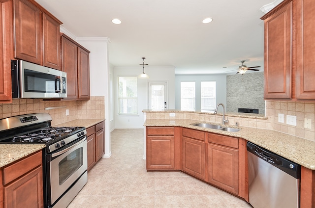 kitchen featuring sink, appliances with stainless steel finishes, ornamental molding, decorative light fixtures, and decorative backsplash