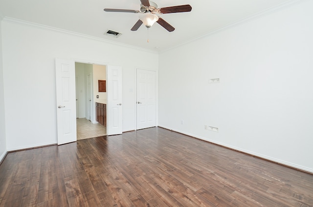 empty room with dark hardwood / wood-style floors, crown molding, and ceiling fan