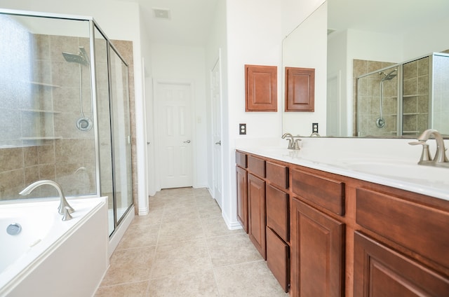 bathroom with vanity, tile patterned flooring, and plus walk in shower