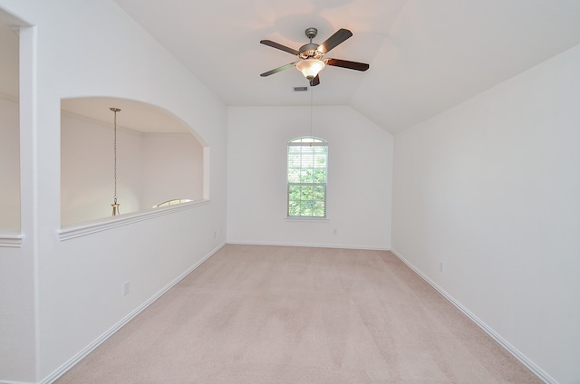 carpeted spare room featuring lofted ceiling and ceiling fan