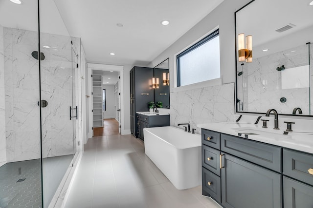 bathroom featuring tile patterned floors, vanity, and plus walk in shower