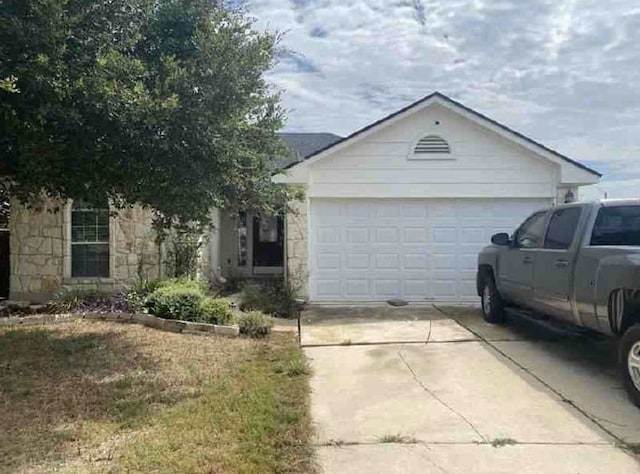 ranch-style house featuring a garage